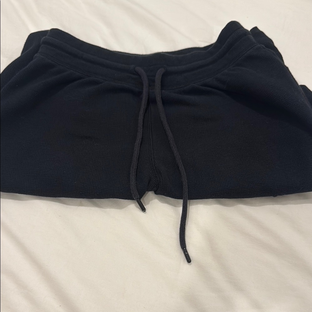 Black Aritzia wide leg ribbed pants.